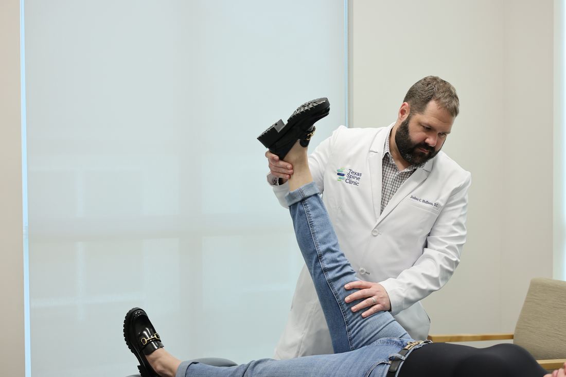 Dr. Joshua C. Huffman performing a straight-leg-raise test on a patient.