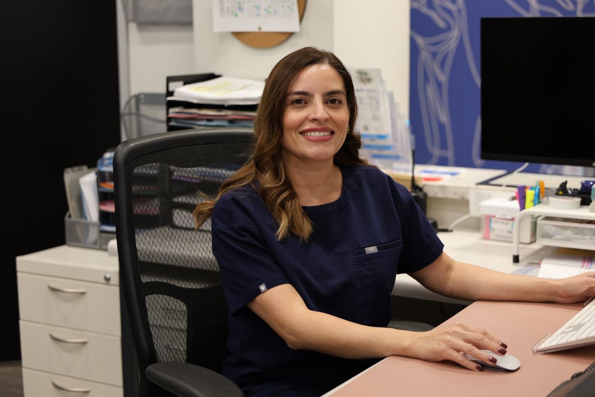 Silvia, the practice manager at Texas Spine Clinic, at her desk.