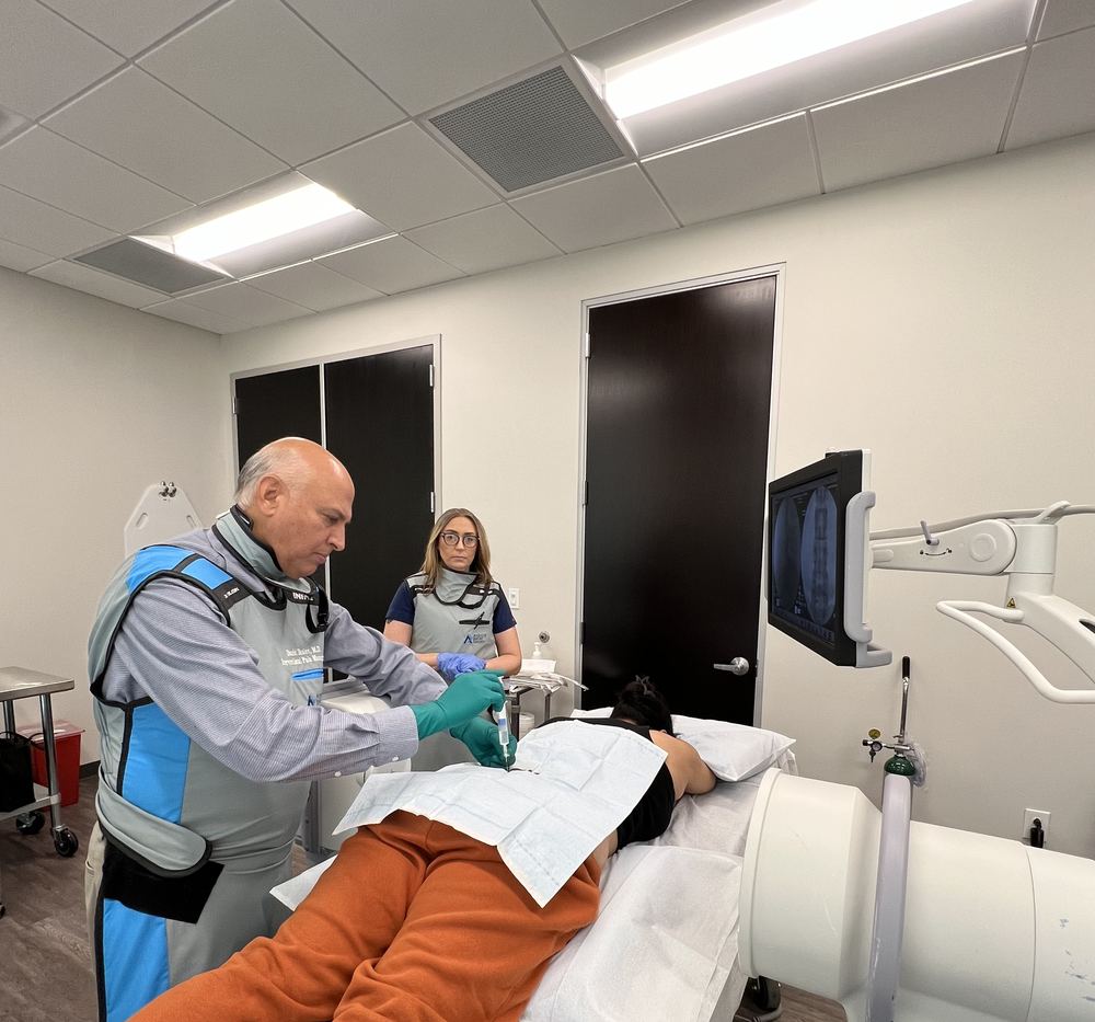 Dr. Praful Singh performing an image-guided procedure in the clinic's procedure room.