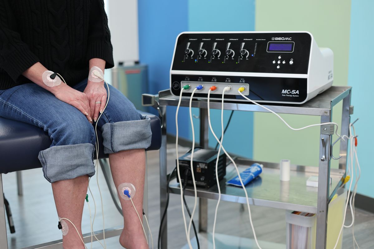 The scrambler therapy machine's five color-coded output channels with electrode cables connected.