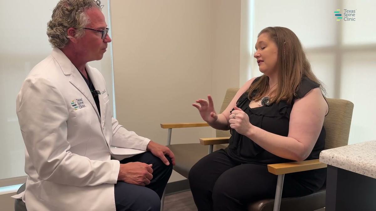 Dr. Barton in conversation with Shannon, a CRPS patient, in a consultation room at Texas Spine Clinic.