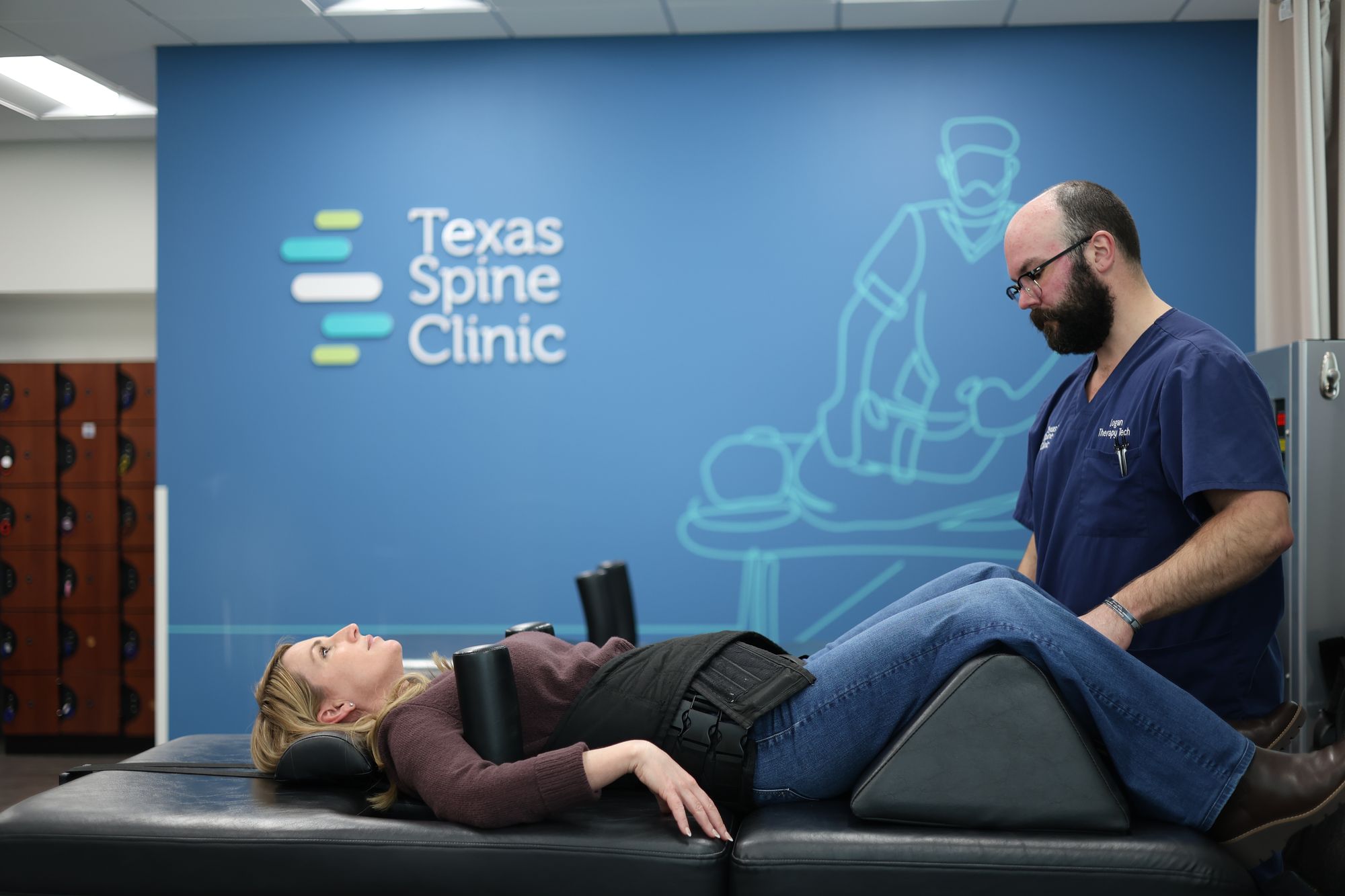 A patient lying on the DRX9000 spinal decompression table at Texas Spine Clinic.