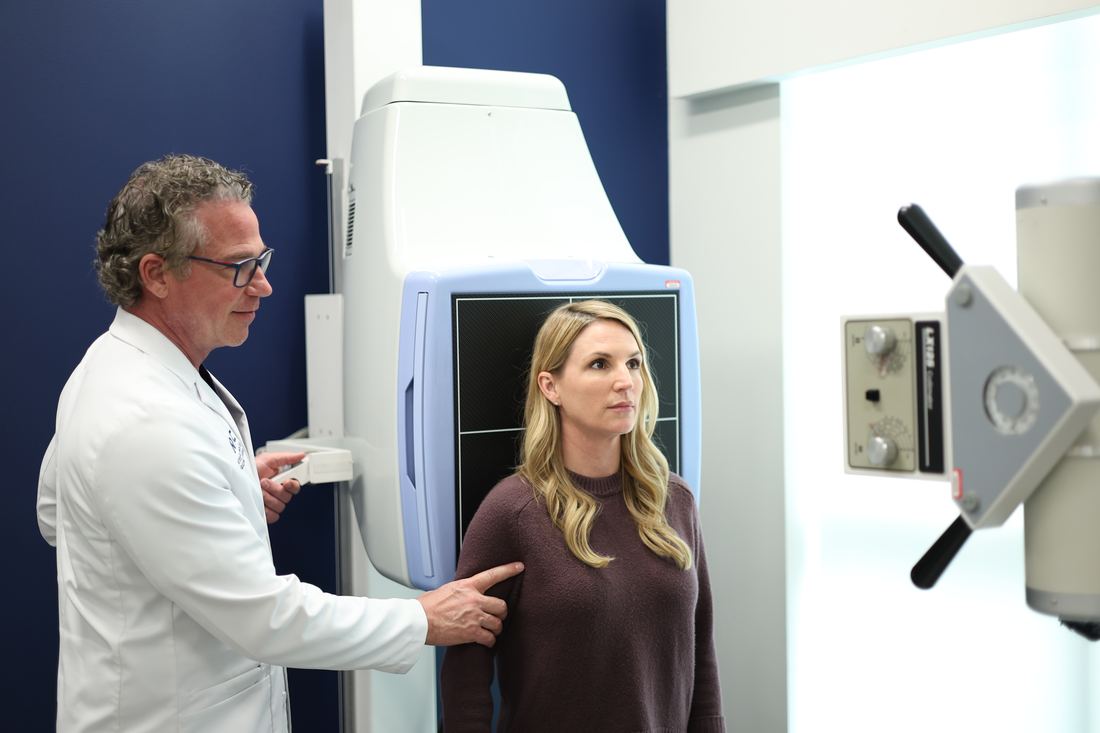 A patient being positioned for lumbar X-rays at Texas Spine Clinic.