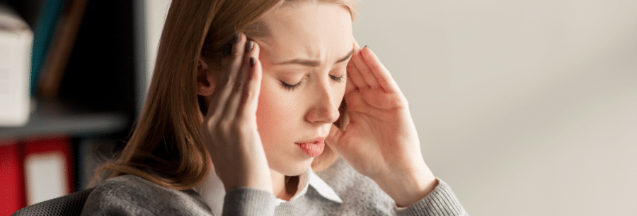 A woman experiences a headache