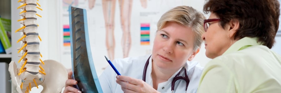 A chiropractor explains the spine to a patient